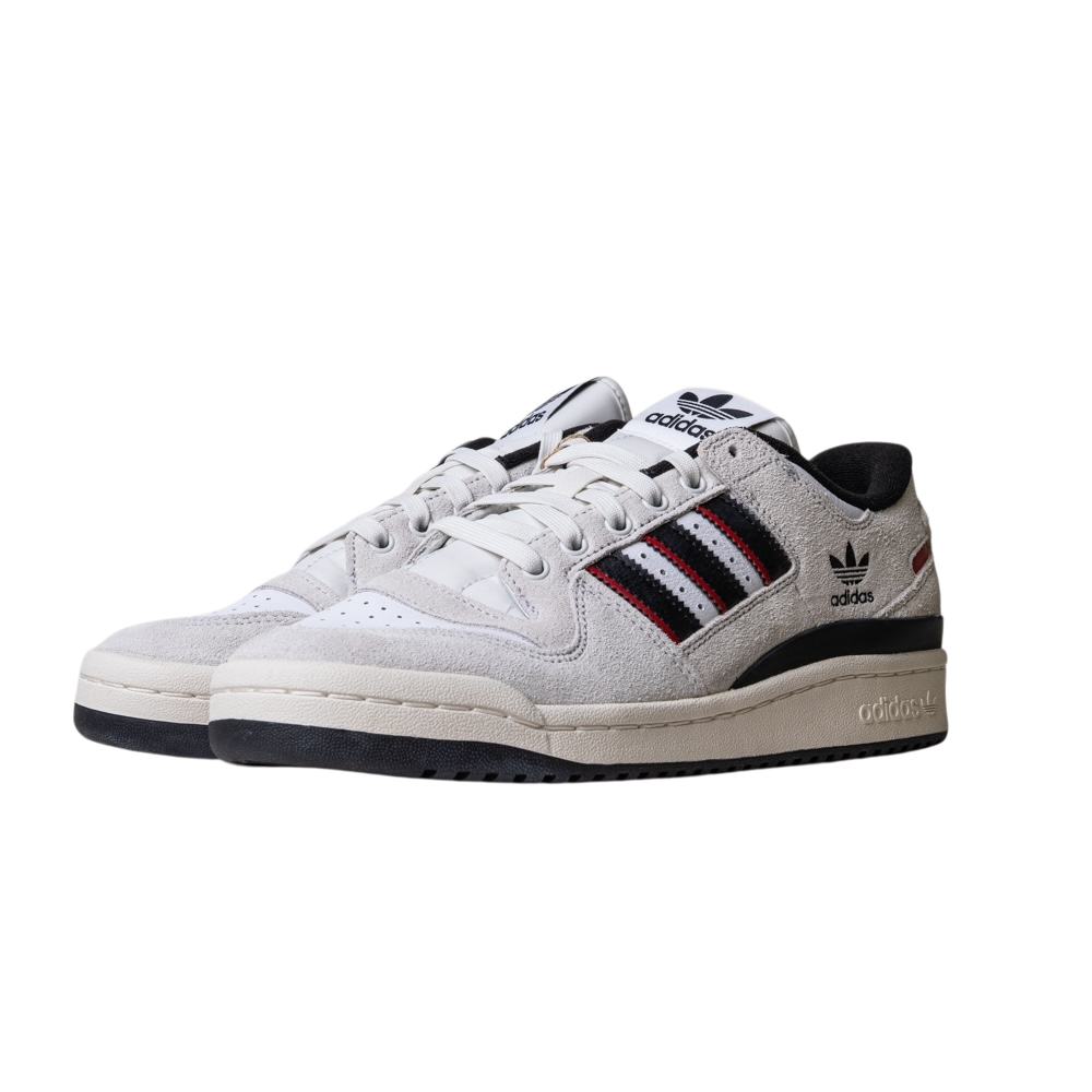 A pair of JP6094 Cry White Core Black Forum 84 Low Adidas Skateboarding suede shoes featuring white suede uppers, black soles, signature three stripes in black, red, and white, with prominent Adidas logos on the tongue and heel.