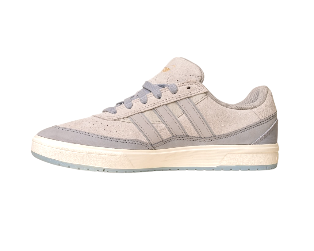 The JI0848 Granite White Tyshawn 2 II Adidas Skateboarding Shoe features a light gray suede and leather upper, gray laces, three stripes, a beige midsole, and a light blue rubber outsole on a plain white background.