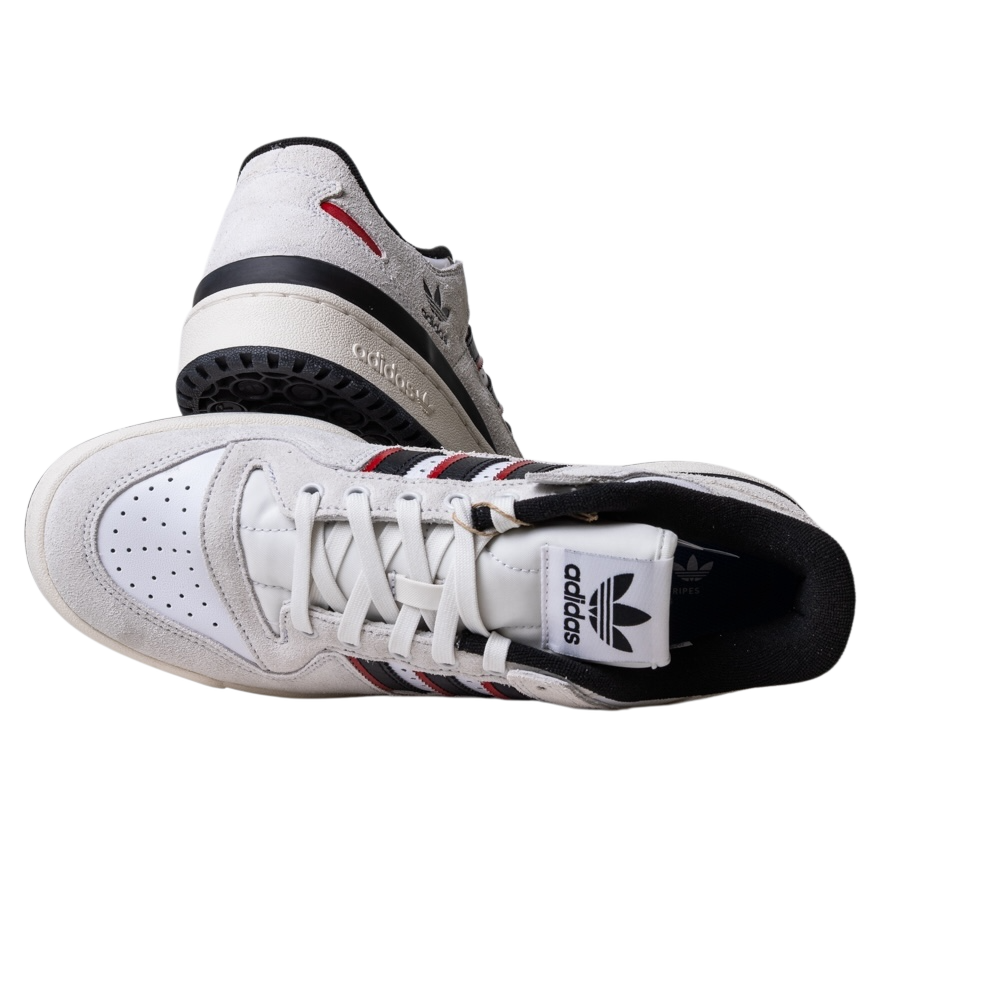 The JP6094 Cry White Core Black Forum 84 Low Adidas Skateboarding suede shoes are showcased: one upright to display the side and sole, the other flat showing the top view and Adidas logo on the tongue.