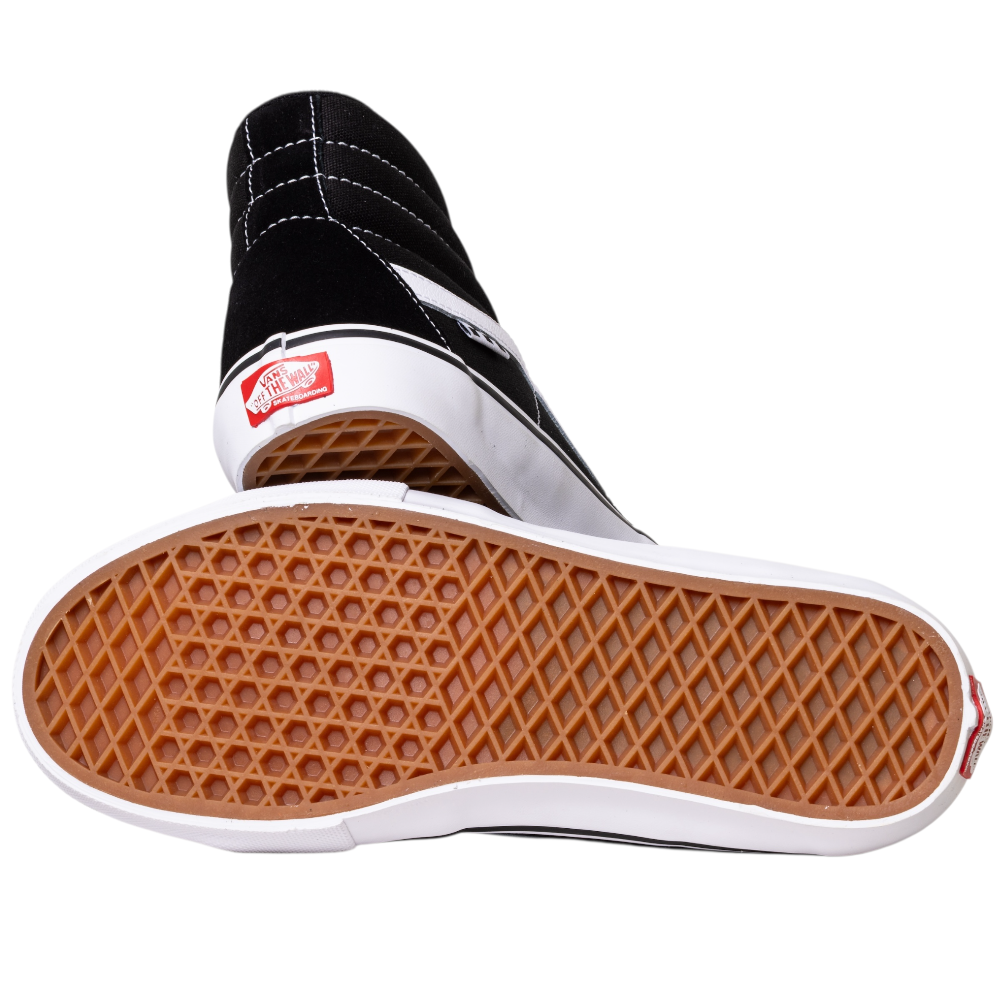The VN0A5FCCY281 Black White Skate SK8-HI Suede Vans Shoes feature white stitching, with one shoe showing the side profile and the other displaying the gum waffle-pattern sole and red Vans heel logo.