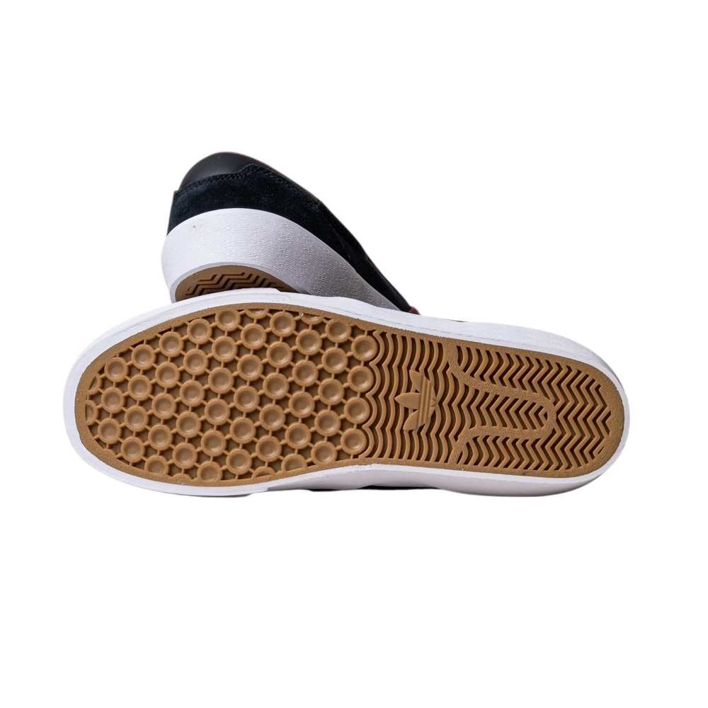 A pair of JQ1044 Black Share Shmoofoil Slip Adidas Skateboarding Suede Shoes is shown in black and white, with one shoe propped up to display its gum-colored, honeycomb-textured outsole against a plain white background.