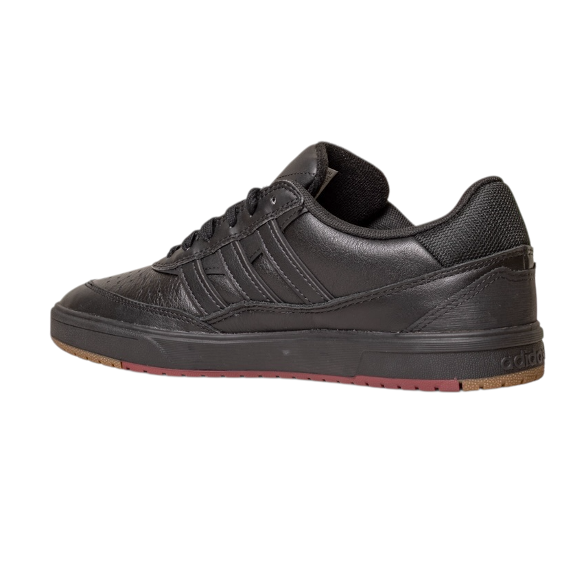 The Tyshawn 2 II Adidas Skateboarding Shoes feature a low-profile leather upper in core black, a rubber sole with green and red accents, and the iconic Adidas three stripes on the side for classic style.