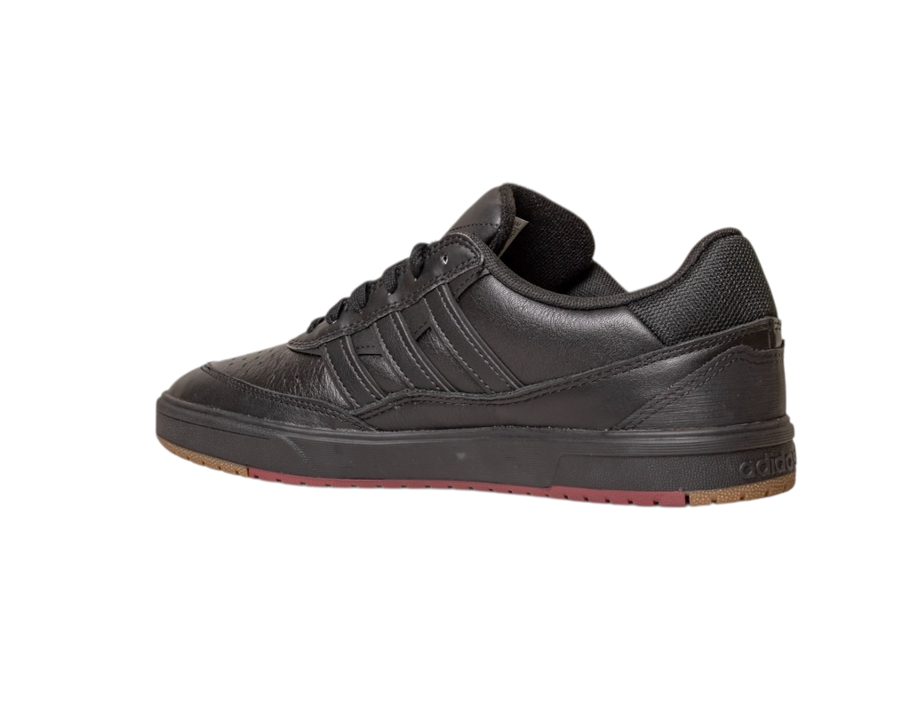 The Tyshawn 2 II Adidas Skateboarding Shoes feature a low-profile leather upper in core black, a rubber sole with green and red accents, and the iconic Adidas three stripes on the side for classic style.