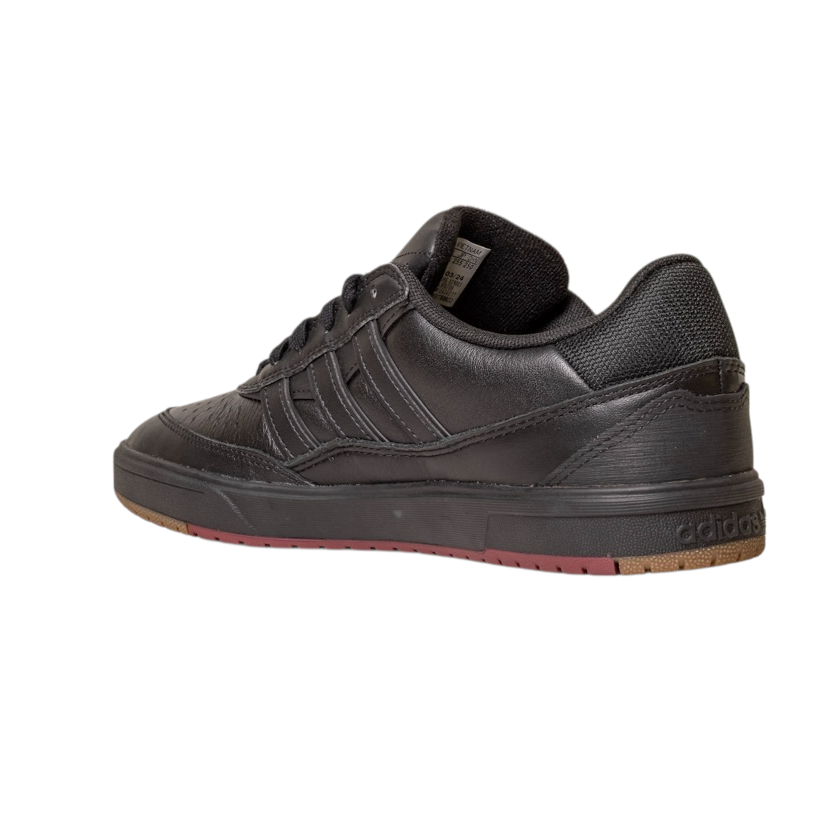 The Tyshawn 2 II Adidas Skateboarding Shoes feature a core black leather upper, low-top design, rubber sole, core green accents, textured detailing, and classic Adidas branding on the heel and sides, with a touch of brown on the outsole.