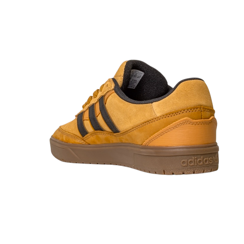 A back-left view of the JI0851 Mesa Black Gum Tyshawn 2 II Adidas Leather Suede Skateboarding Shoes, yellow and brown with black stripes, cupsole construction, isolated on a white background.