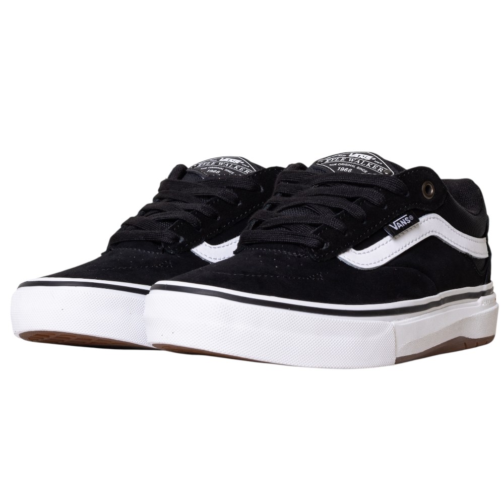 A pair of black VN000DA4MCG1 Skate Kyle Walker Wafflecup Vans shoes in suede with white accents, brown rubber outsoles, and black laces—shown side by side on a white background.