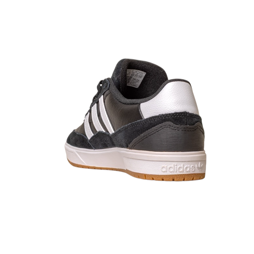 The JI 0846 Black White Gum Tyshawn 2 II Adidas Skateboarding leather suede shoe features three white stripes, a white sole, and Adidas heel logo. Shown from the back-left, it is black and white, with a classic skate design, isolated on white.