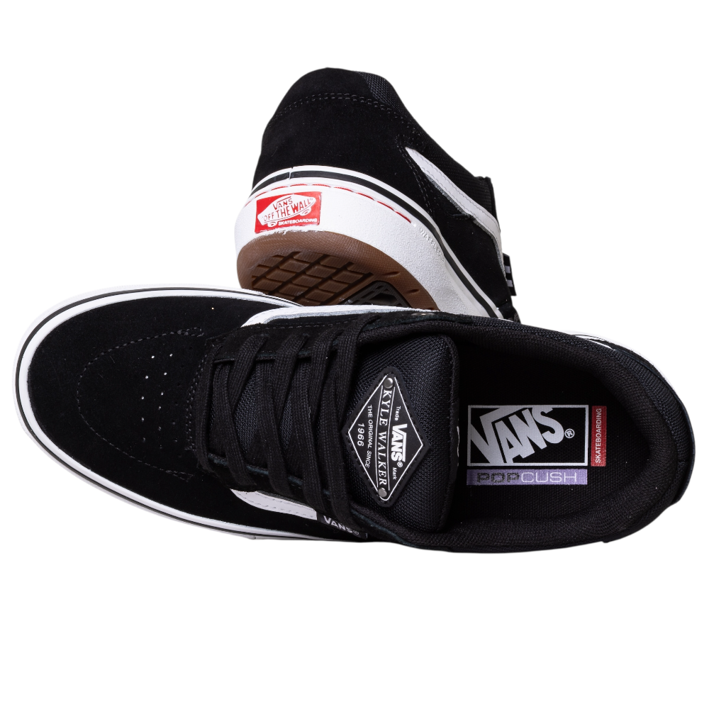 The VN000DA4MCG1 Skate Kyle Walker Wafflecup Black White Vans feature black suede with white accents, Vans logos on tongue and heel, PopCush insoles for comfort, and a brown waffle-patterned rubber sole.