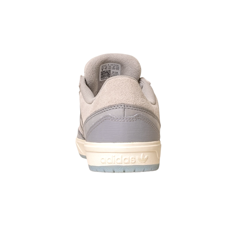 A rear view of the JI0848 Granite White Tyshawn 2 II Adidas skateboarding shoe featuring a beige leather and suede upper, light gray heel accent, cream sole, and embossed Adidas logo on the back heel. The shoe is isolated on white.