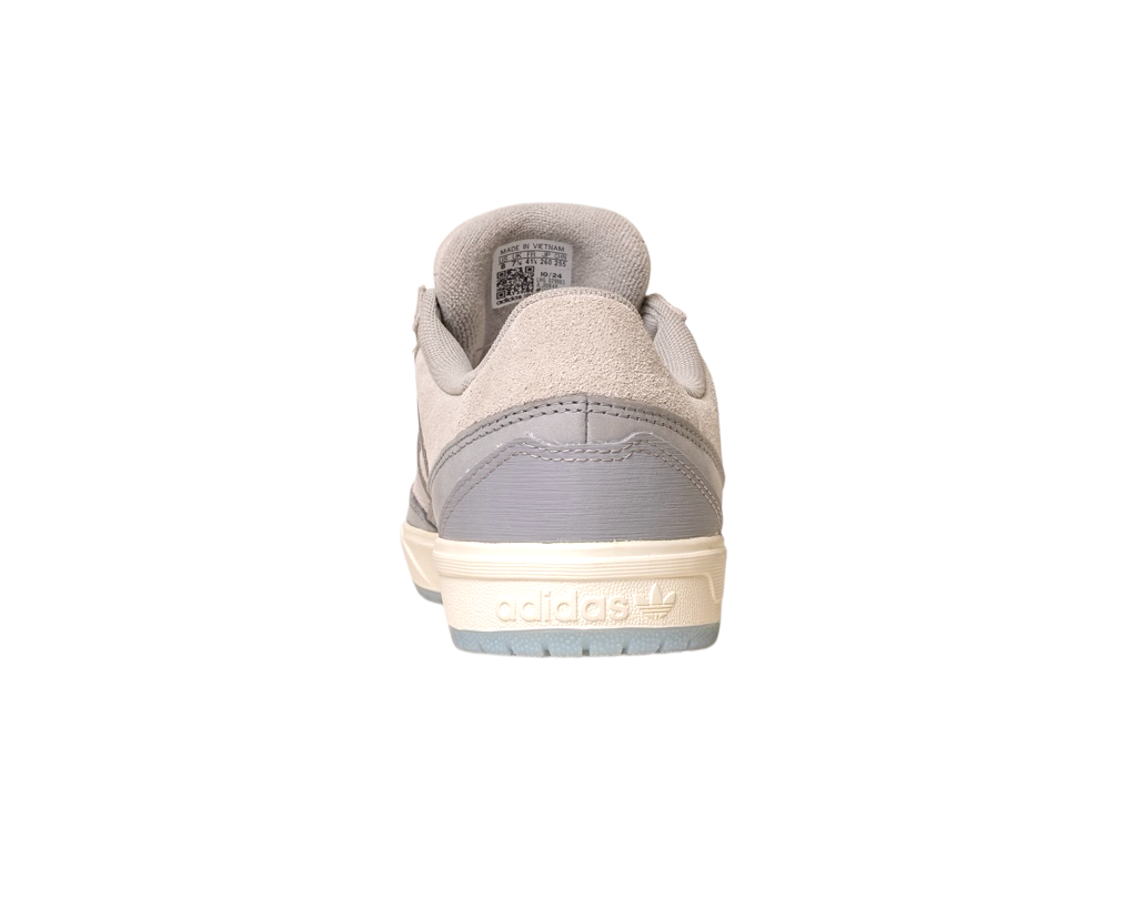 A rear view of the JI0848 Granite White Tyshawn 2 II Adidas skateboarding shoe featuring a beige leather and suede upper, light gray heel accent, cream sole, and embossed Adidas logo on the back heel. The shoe is isolated on white.
