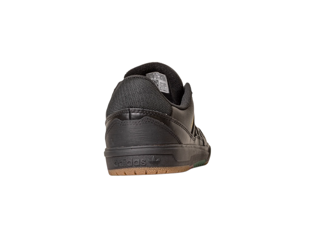 A Tyshawn 2 II Adidas Skateboarding Core Black/Core Green leather shoe, viewed from the back, displays the heel, gum-finished sole segment, and embossed Adidas logo on the leather heel tab. The shoe is centered on a white background.