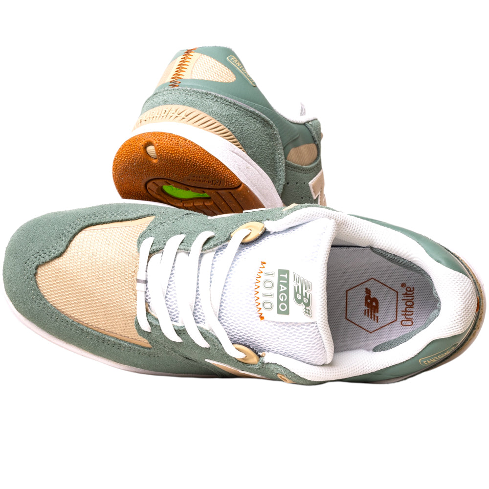 A pair of 1010TC Dark Juniper Sandstone Tiago Lemos New Balance Numeric suede skateboarding shoes, featuring green, beige, and white mesh uppers with branding—one upright, one showing its brown sole—for pro-level skate sessions.