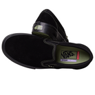 A pair of VN000EKPGSH Black Black Olive Skate Slip On Vans suede shoes featuring white stitching, green POPCUSH insoles, and the Vans “Off The Wall” logo on the heel. One shoe is on its side; the other stands upright.