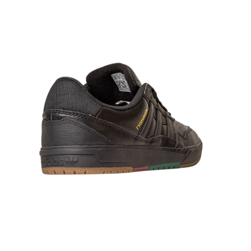 The Tyshawn 2 II Adidas Skateboarding Core Black/Core Green Leather Shoe, seen from the back left, features mesh and leather, a textured sole with brown and green accents, and "HANDBALL" in gold—a modern spin for skate shoe fans.