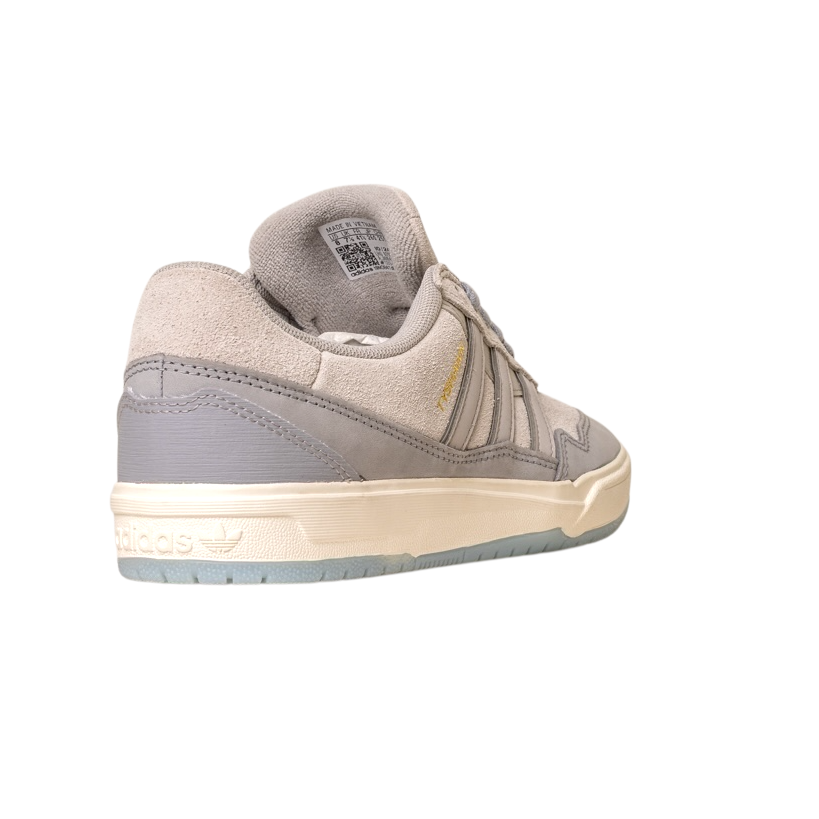 The JI0848 Granite White Tyshawn 2 II Adidas Skateboarding Shoe is shown from the back left, highlighting its suede and leather textures, gold branding, cream sole, and translucent blue outsole on a white background.