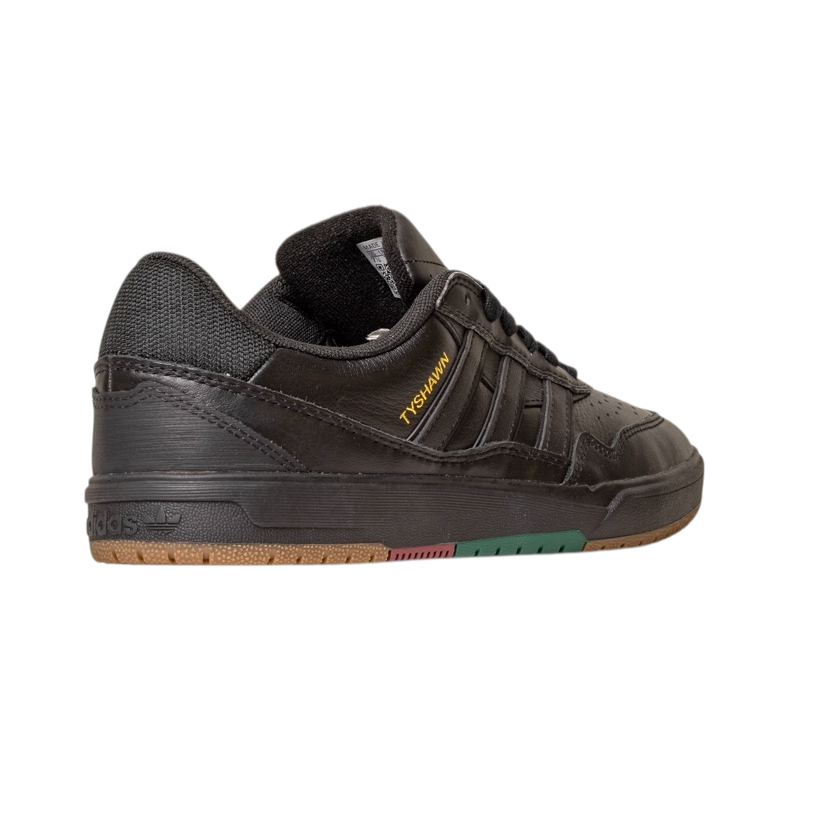 The Tyshawn 2 II Adidas Skateboarding Leather Shoe in Core Black/Core Green features "YOUTH OF PARIS" in yellow on the side, with a brown and green rubber sole, shown from a rear side angle on a white background.