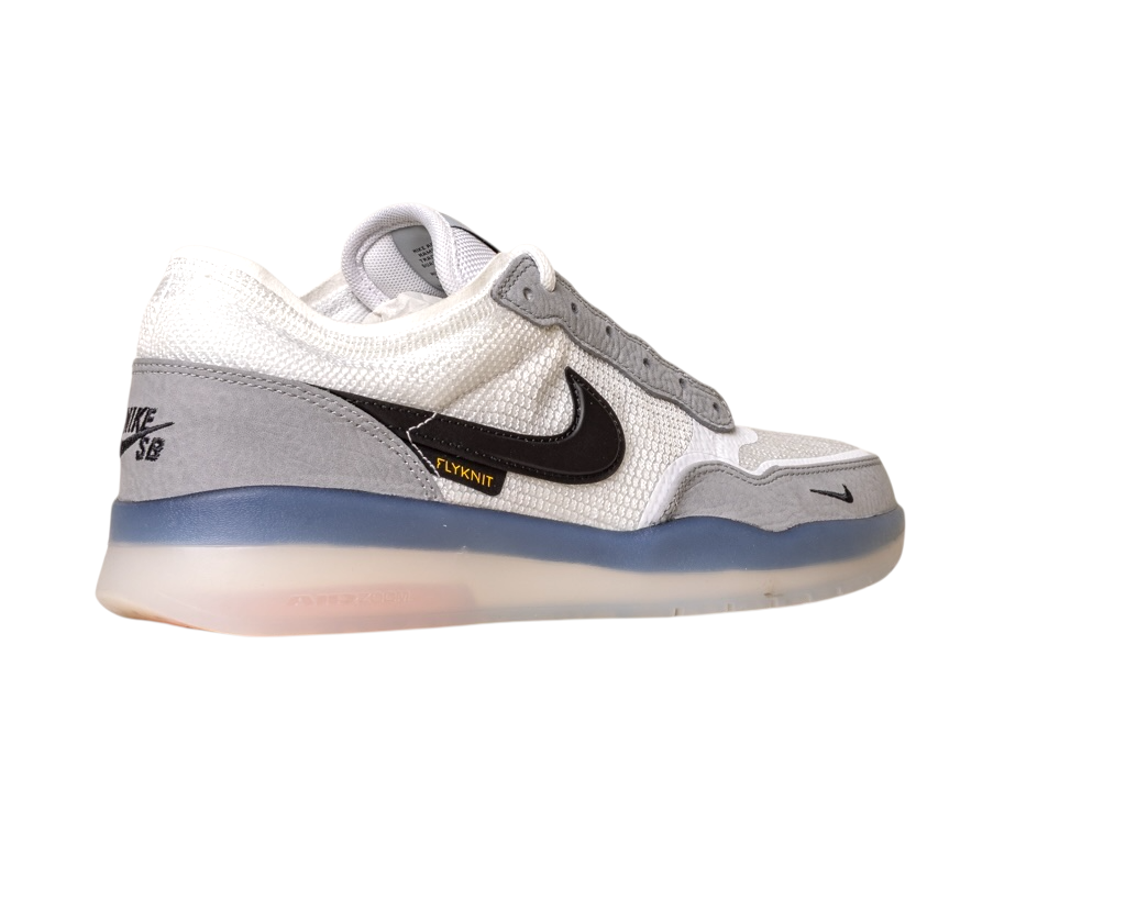 The FV8493-004 Grey White PS8 Nike SB Leather Knit Shoes are low-tops featuring a white and gray upper, black Swoosh, FLYKNIT label, HART outsole, translucent blue sole, and NIKE SB branding on the heel.