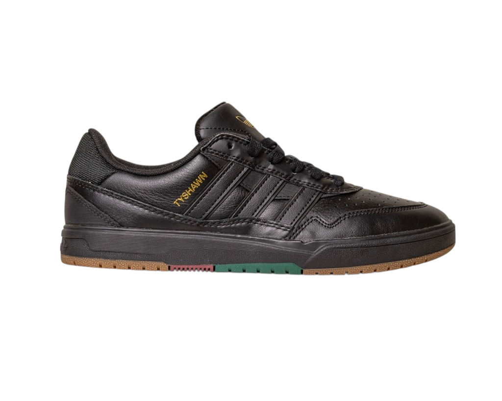 The Tyshawn 2 II Adidas Skateboarding Shoes feature black leather, a textured sole with green and gum accents, black laces, perforated toe, stitched details, and gold Y*S*K*MIN branding on the side, inspired by classic skateboarding styles.