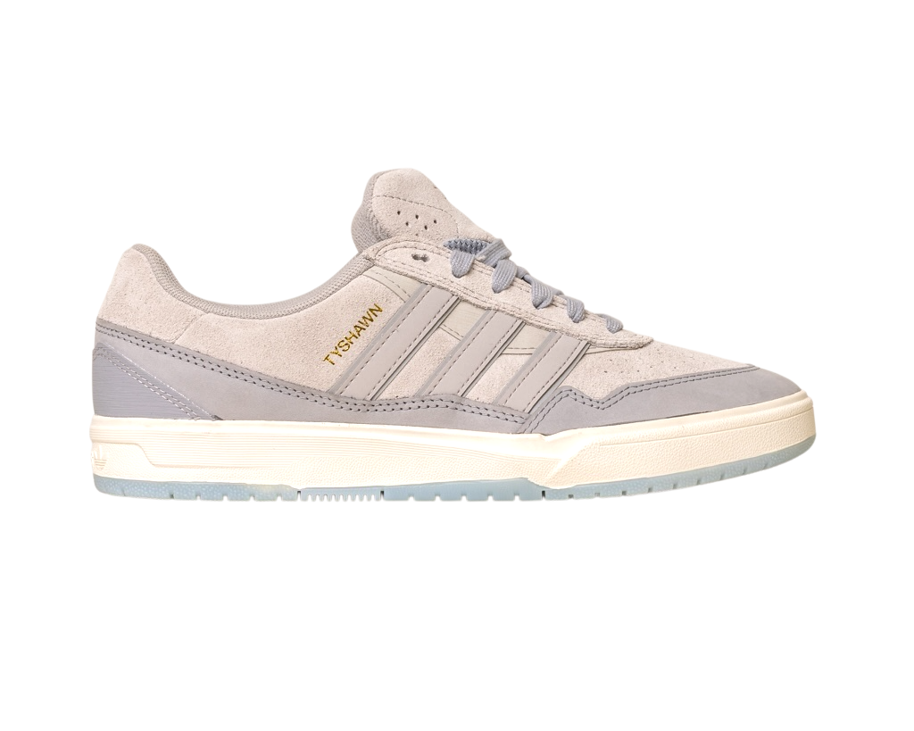 The JI0848 Granite White Tyshawn 2 Adidas Skateboarding Shoes feature light gray suede and leather, gray laces, three signature stripes, gold "TYSHAWN" text, and a white rubber sole with a light blue translucent bottom.