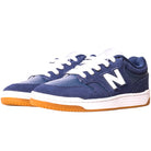 A pair of 480BEE Navy White New Balance Numeric suede skateboarding shoes with white laces, white midsoles, gum outsoles, and a white N logo, inspired by heritage basketball styles, shown angled on a white background.