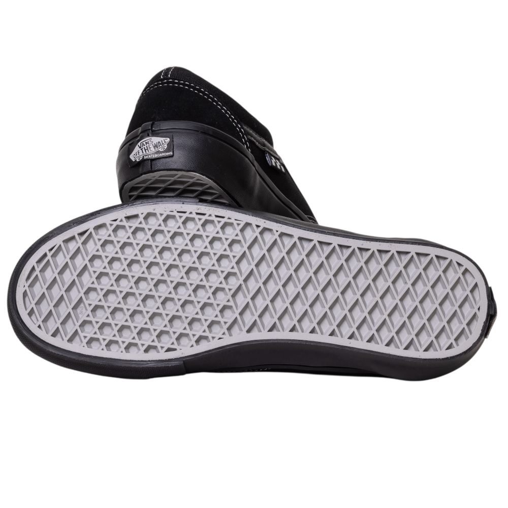 A pair of VN000EJ3174 Black Black Grey Skate Old Skool Vans Suede Skateboarding Shoes, with one shoe on its side revealing the iconic waffle-patterned sole—classic kicks featured in Tony Hawk Pro Skater games.