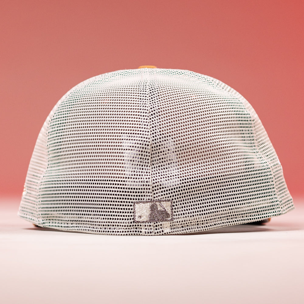The 17WS Pink Trucker Houston Astros New Era Hat 5950 Fitted is shown from the back against a pink background, featuring a white mesh design, adjustable snap closure, and a small rectangular patch at the bottom center.