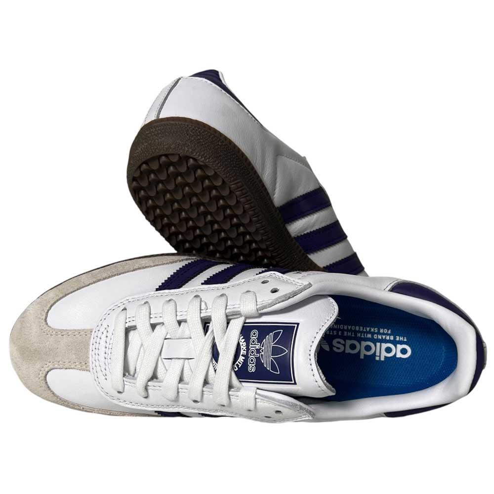 A pair of Purple White Samba ADV Adidas Skateboarding Leather Suede Shoes featuring purple stripes and logo, white uppers, blue insoles, and beige suede accents. One shoe is top view, the other side view, showing the textured brown sole.