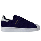A purple Adidas Skateboarding Superstar ADV suede shoe with reflective badging, gold “SUPERSTAR” text on the side, and featuring a signature Adidas design.