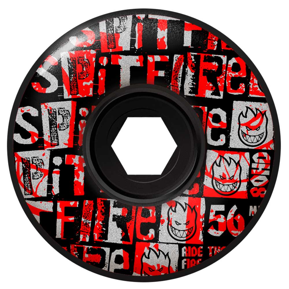 The Ransom Radial Full 56mm 80HD Black Spitfire Wheels feature a bold graffiti-style design in red, white, and gray with scattered text, cartoon flaming head logos, and the number 56 along with the word FIRE.