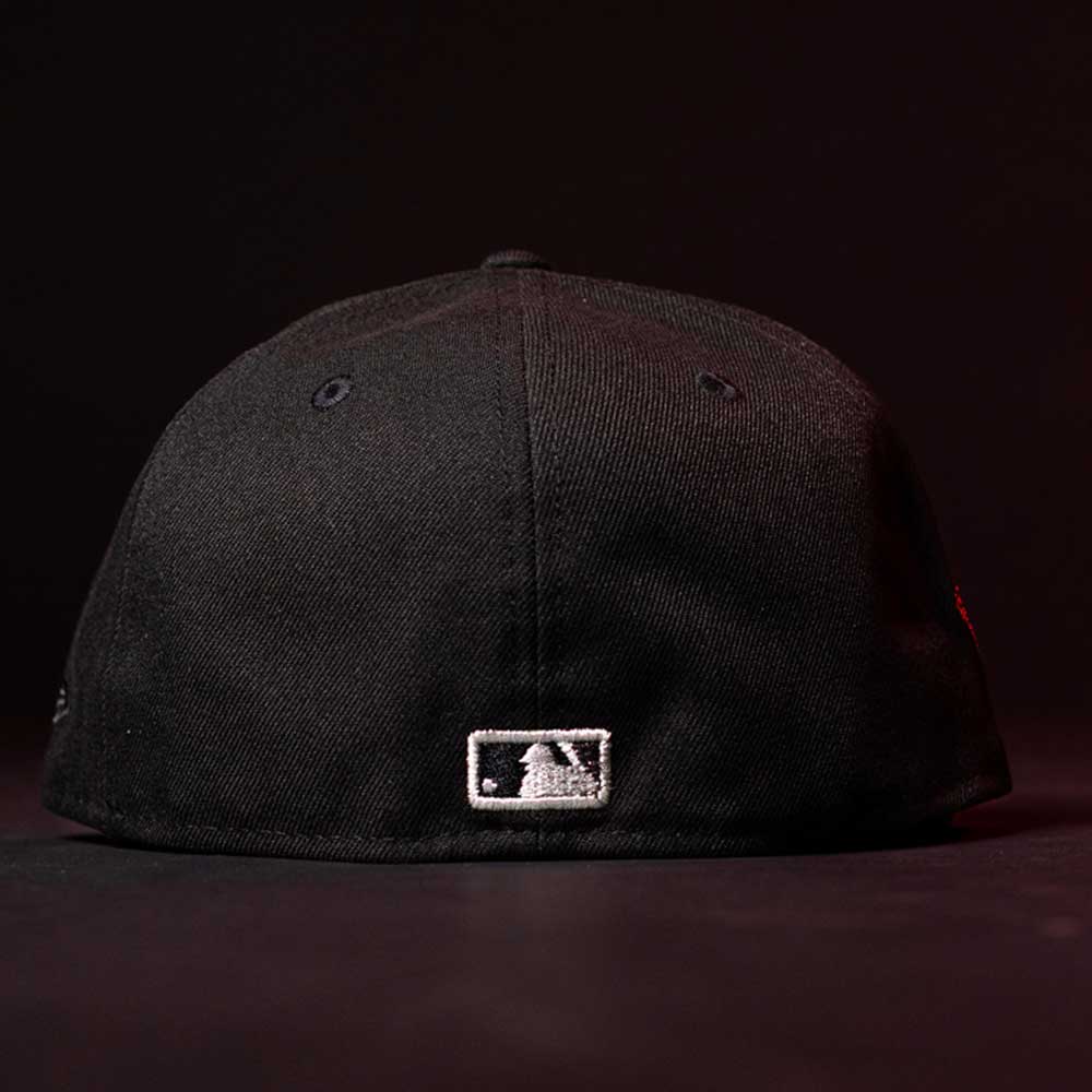 A Red Dot Red City Connect Houston Astros New Era 5950 Fitted Hat is shown from the back, featuring the MLB logo. Now available for pre-order with in-store pick-up options. The background is dark.