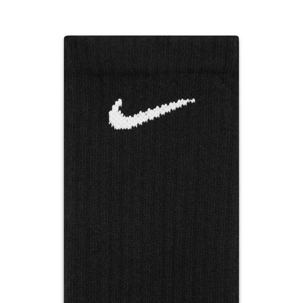 A close-up of the SX7666010 Black White Nike SB Socks Crew 6 Pack, featuring a black fabric with an embroidered white Nike swoosh logo, highlights the comfort and support of these cushioned training socks.