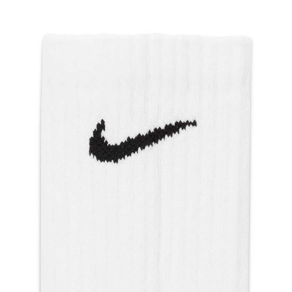 Close-up of a white Nike SB Crew Sock from the SX7666100 6 Pack, featuring a black Swoosh logo near the top.