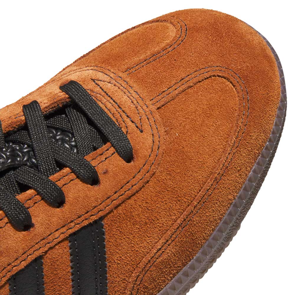 Close-up of the Samba ADV Brown Black HQ9286 Adidas Skateboarding shoe, featuring a leather suede upper, black laces, black side stripes, and detailed stitching reminiscent of classic athletic style.