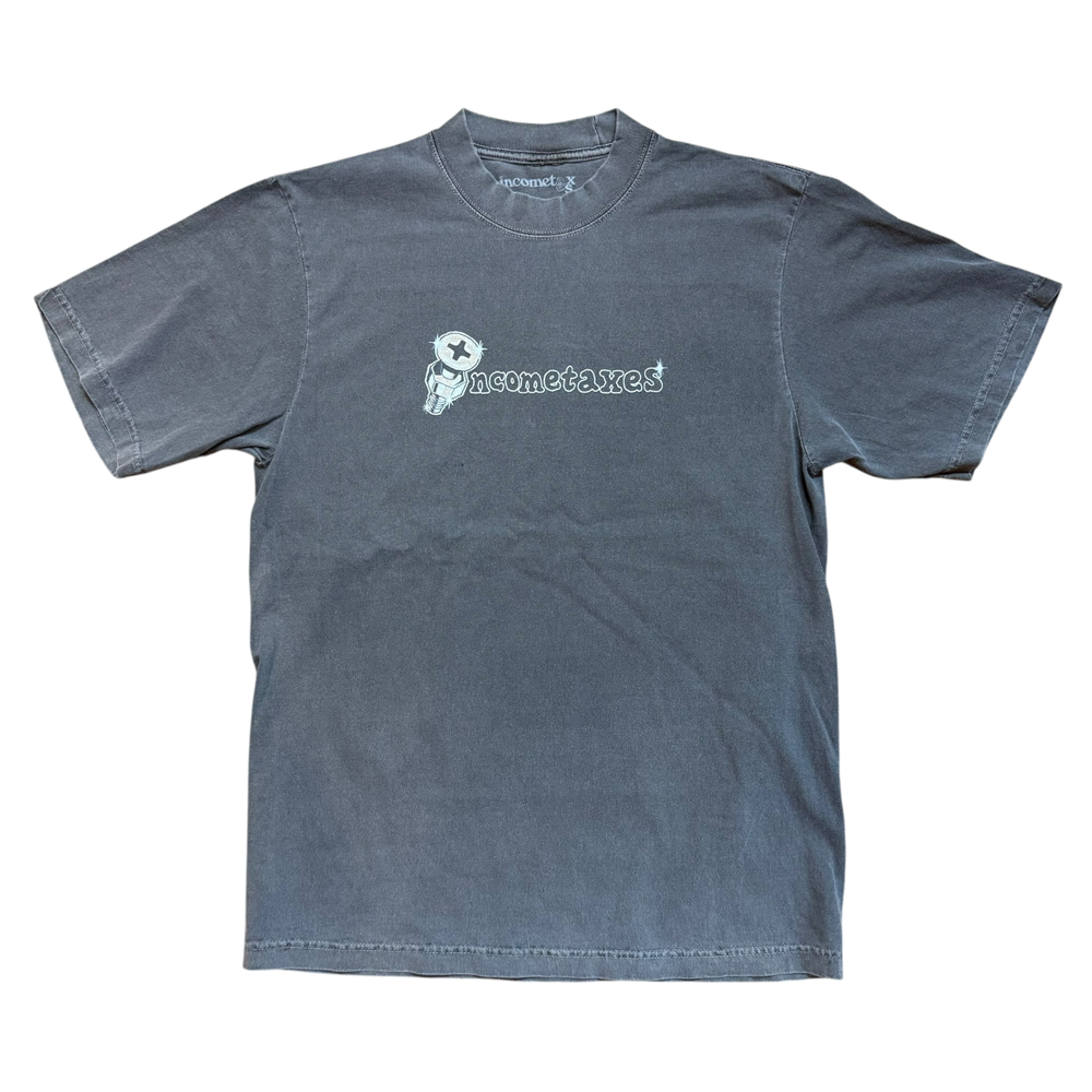 The Screw Head Tee Gray Income Taxes is a faded gray premium USA cotton T-shirt with a small cartoon skeleton graphic and “gnometaxes” in white, ideal for a laid-back streetwear vibe.