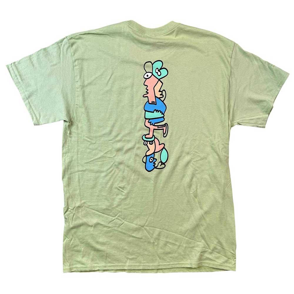 The Sebo Walker x Southside Skatepark Avacado Tee in light green features a vertical back graphic of three stacked cartoon faces with pink skin, blue features, and playful expressions, inspired by Southside Skatepark style.