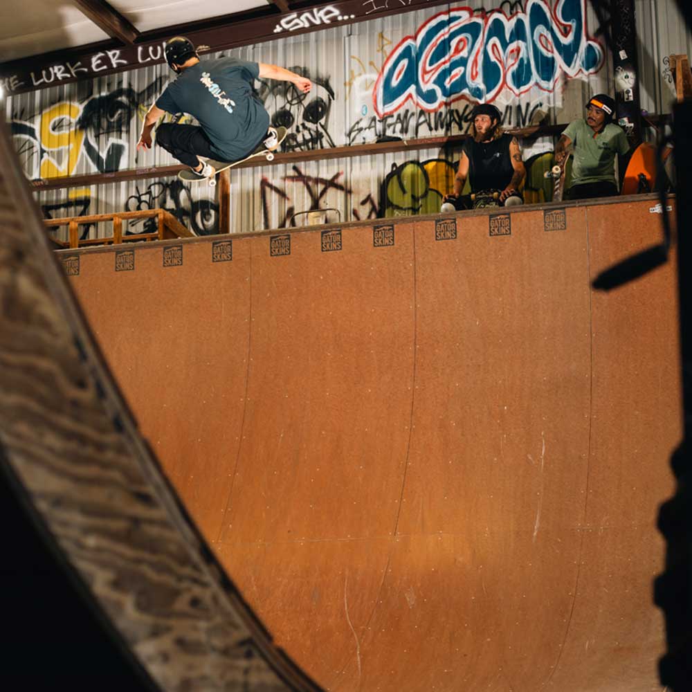 Sebo Walker wears the Sebo Walker x Southside Skatepark Blueberry Tee while skateboarding on a ramp at Southside Skatepark.