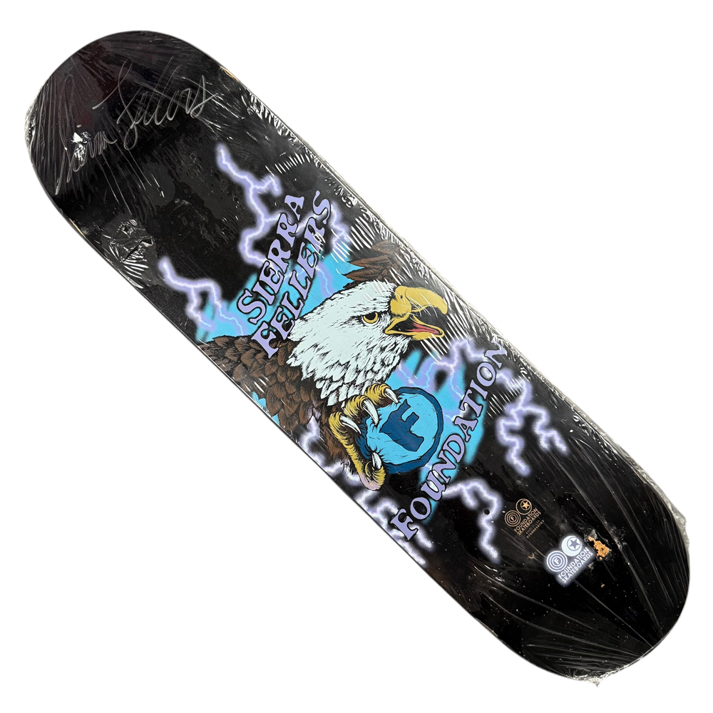 The Sierra Fellers Foundation 8x31.2 Black Dipped Autographed Collectible Skateboard Deck features a bald eagle clutching a blue “F” with lightning bolts, “Sierra Fellers” above, “Foundation” below, and comes wrapped in clear plastic.