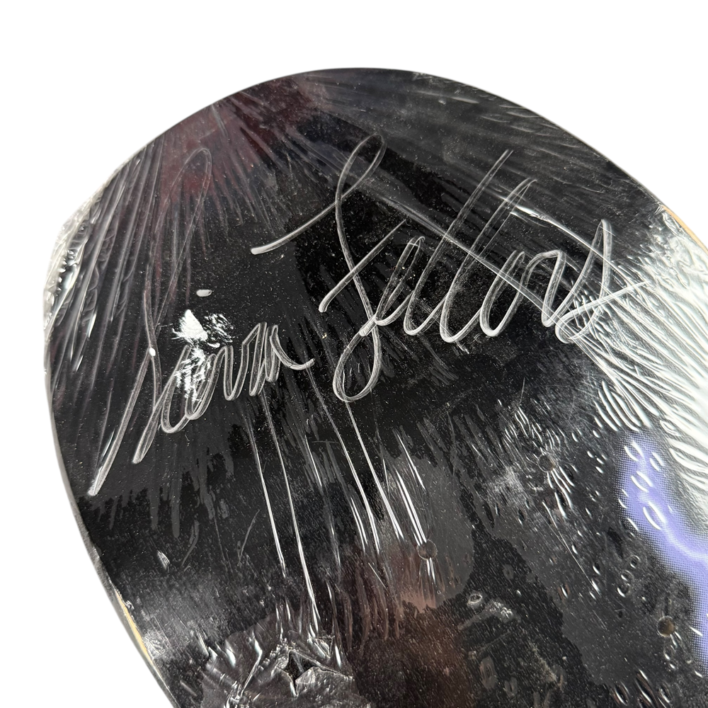The Sierra Fellers Foundation 8x31.2 Black Dipped Autographed Collectible Skateboard Deck is a black, plastic-wrapped deck featuring a bold white signature—ideal for fans wanting an exclusive collectible piece.