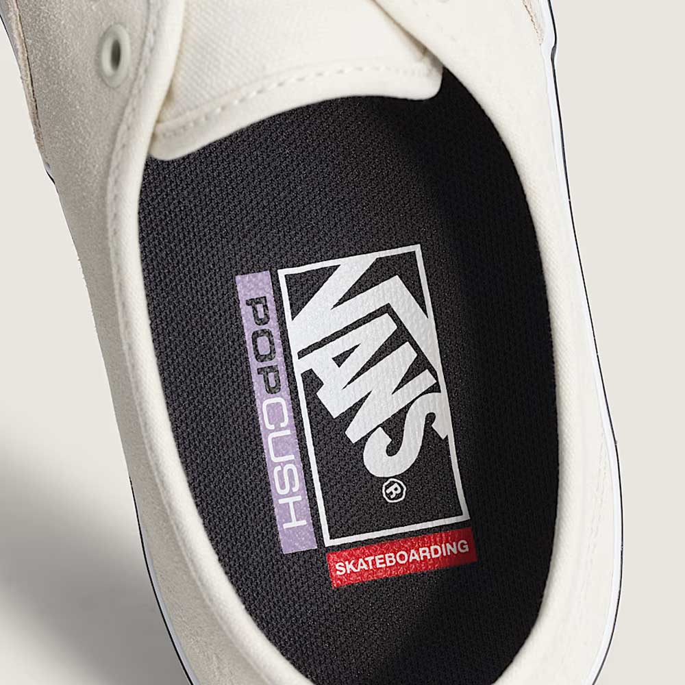 Close-up of the Skate Authentic White Gunmetal Vans VNOA5FC8XQL Suede White Skateboarding Shoe’s interior, featuring a durable Pop Cush insole with Vans, Skateboarding, and Pop Cush logos for enhanced comfort and grip traction.