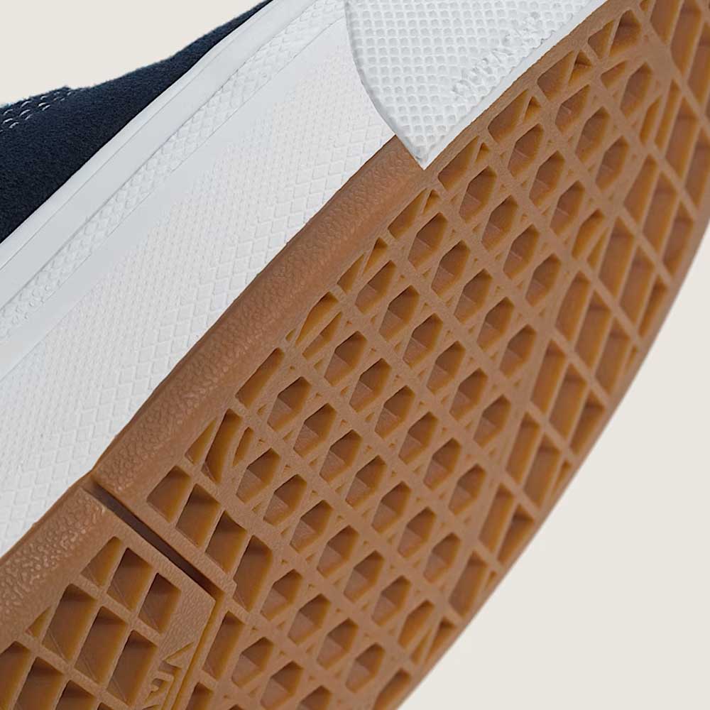 Close-up of the textured rubber WaffleCup outsole on the Skate Era Wafflecup Navy Blue Bell VN000EF0J4I1 Vans Suede Rubber Shoes, highlighting the brown gum tread and a section of the white sneaker edge.