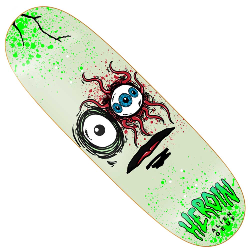 The Space Egg 3 10 Heroin Skateboards Deck Shaped features a surreal cartoon face with three blue eyes, bloodshot veins, and a warped mouth on a splattered light green background. Made from 7-ply hard rock maple, with "HEROIN" at the bottom.