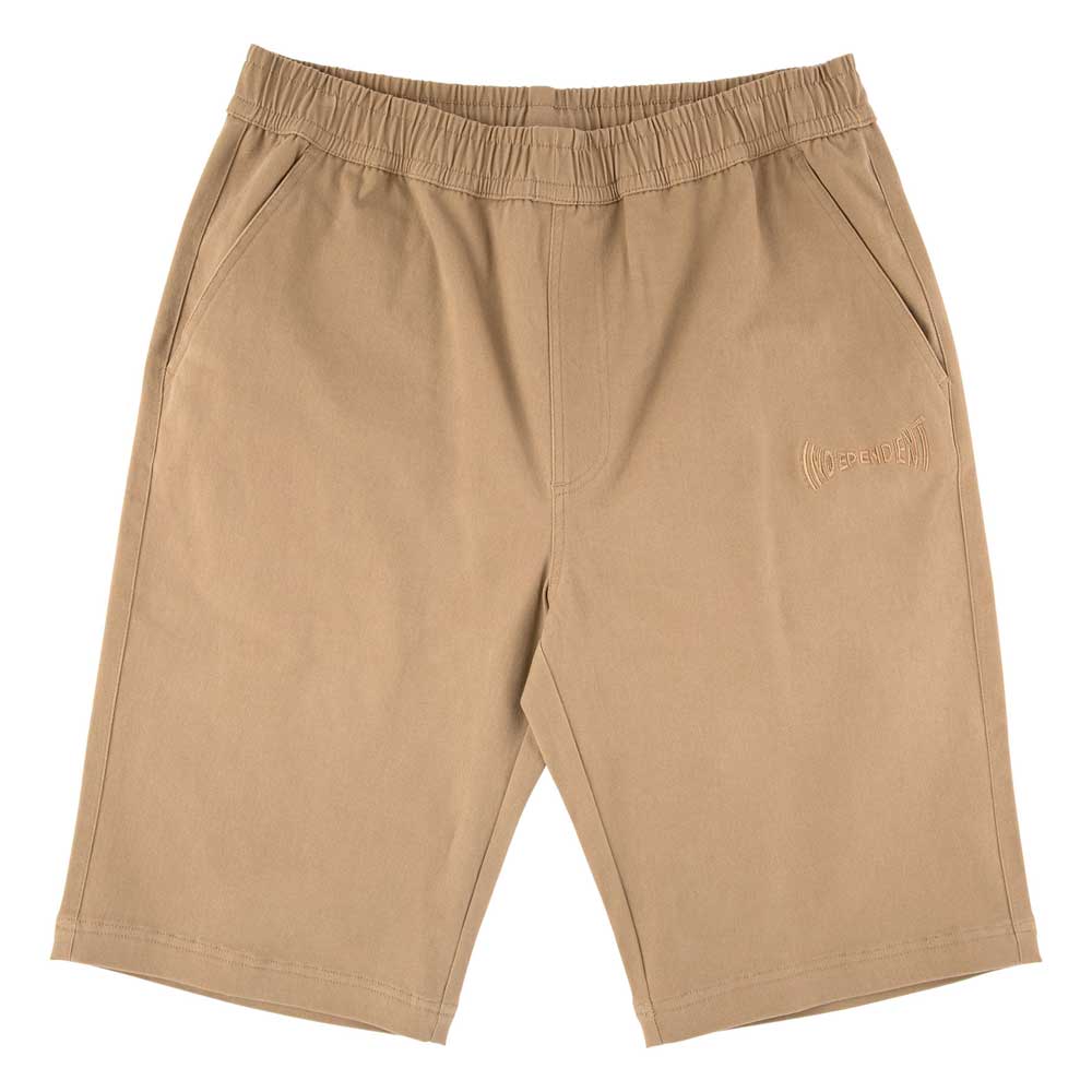 The Span Elastic Waist Shorts in khaki for men feature a baggy fit, long inseam, side pockets, and subtle left thigh embroidery. Inspired by Independent Trucks apparel. Laid flat on a white background.