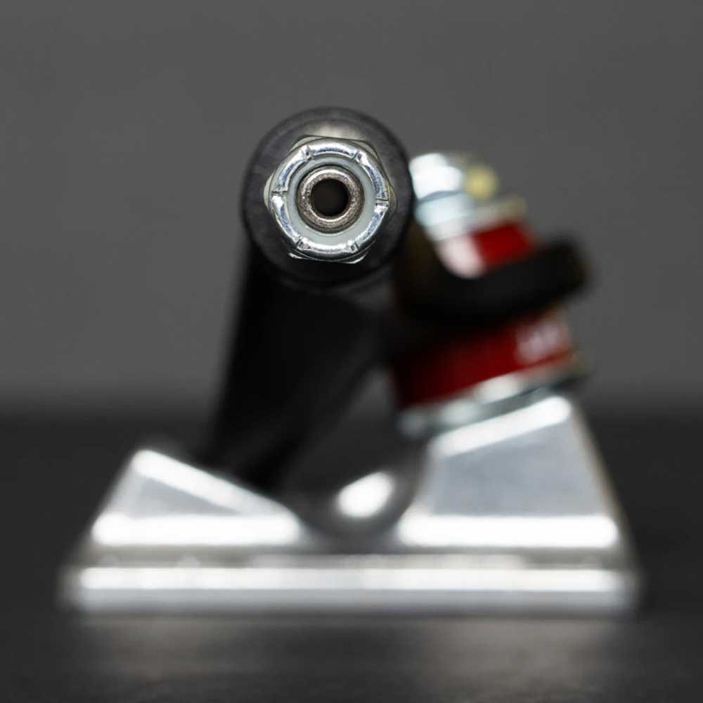 Close-up of a Stage 4 Eric Dressen Pro 166 Black Silver Standard INDY Truck, highlighting the axle nut, kingpin, baseplate, and hanger against a blurred dark background. Set includes two skateboard trucks.