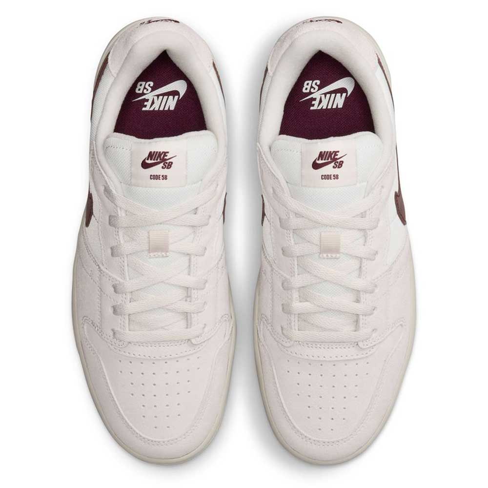 Summit White Mystic Dates Code 58 IB0108102 Nike SB Skateboarding Suede Shoes in white with a maroon swoosh and branding on the tongue and insole.