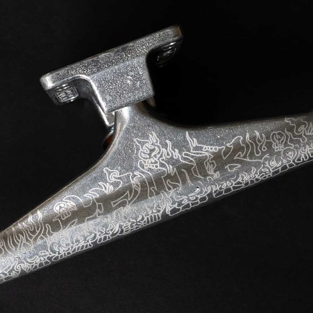 Close-up of the T Funk Polished Silver Standard INDY 159 Stage 11 Trucks Set of TWO, featuring durable aluminum construction and engraved patterns, set against a black background.