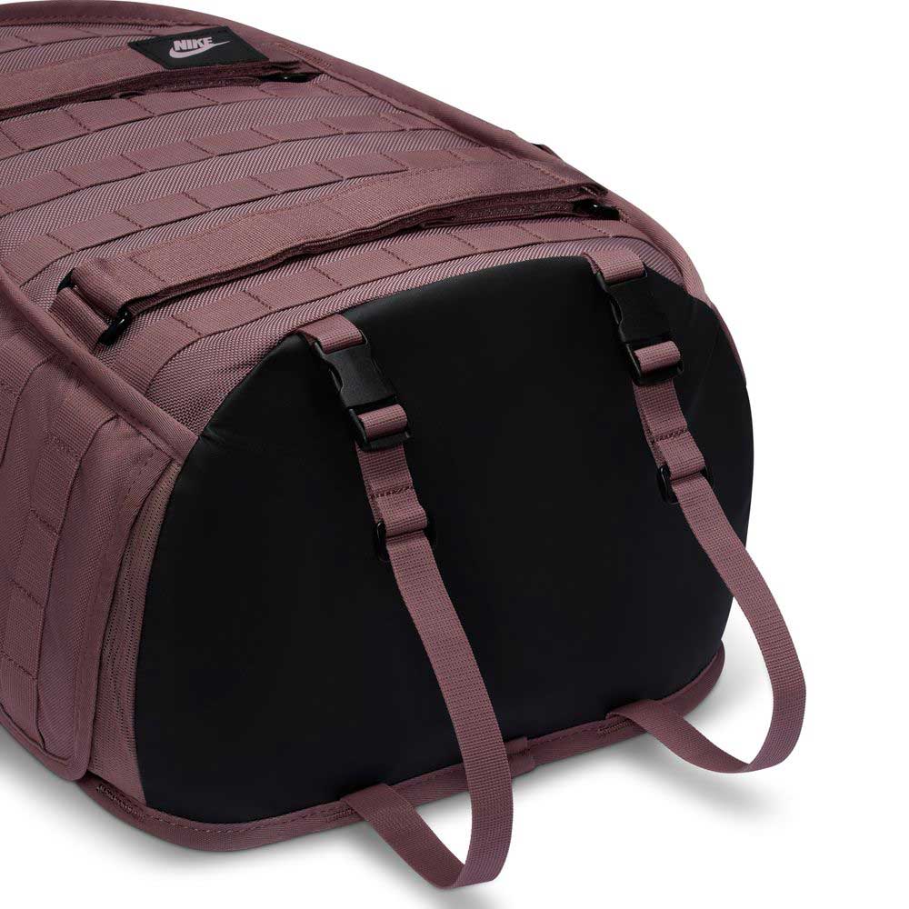 A close-up of the Tattoo Black Light Violet FD7544502 Nike SB RPM Skate Backpack showcases its reinforced black base, adjustable straps, water-resistant fabric, and MOLLE webbing—ideal for skateboarding.