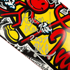A close-up of the Team World Industries Skateboards Deck 7.75x31.2 Circa 2007 Signed Collectible, featuring bold red, yellow, and black graphics with a silver "Rosen Xauler 2007 $K8" autograph.
