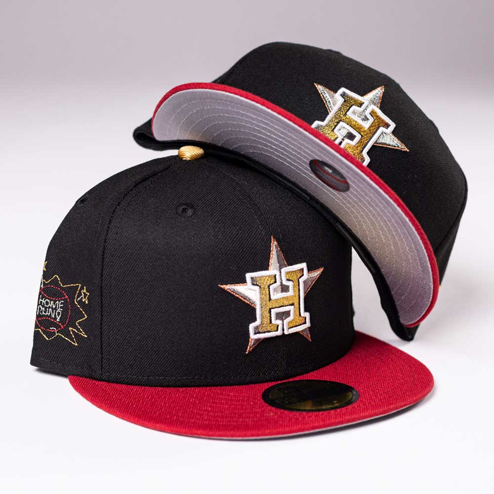 Two black “The Last Call New Era Hat 5950 Fitted NEW YEAR DROP” caps with red brims feature a gold and white H inside a star and a Home Run patch. One stands upright, the other leans against it—get yours before it’s gone!.