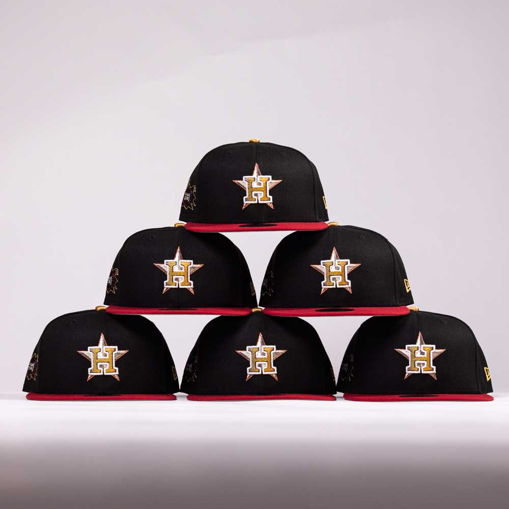 Six black and red The Last Call New Era Hat 5950 Fitted NEW YEAR DROP caps, each with a gold and white H star logo, are stacked in a pyramid on a plain white background—perfect for your last call pick.
