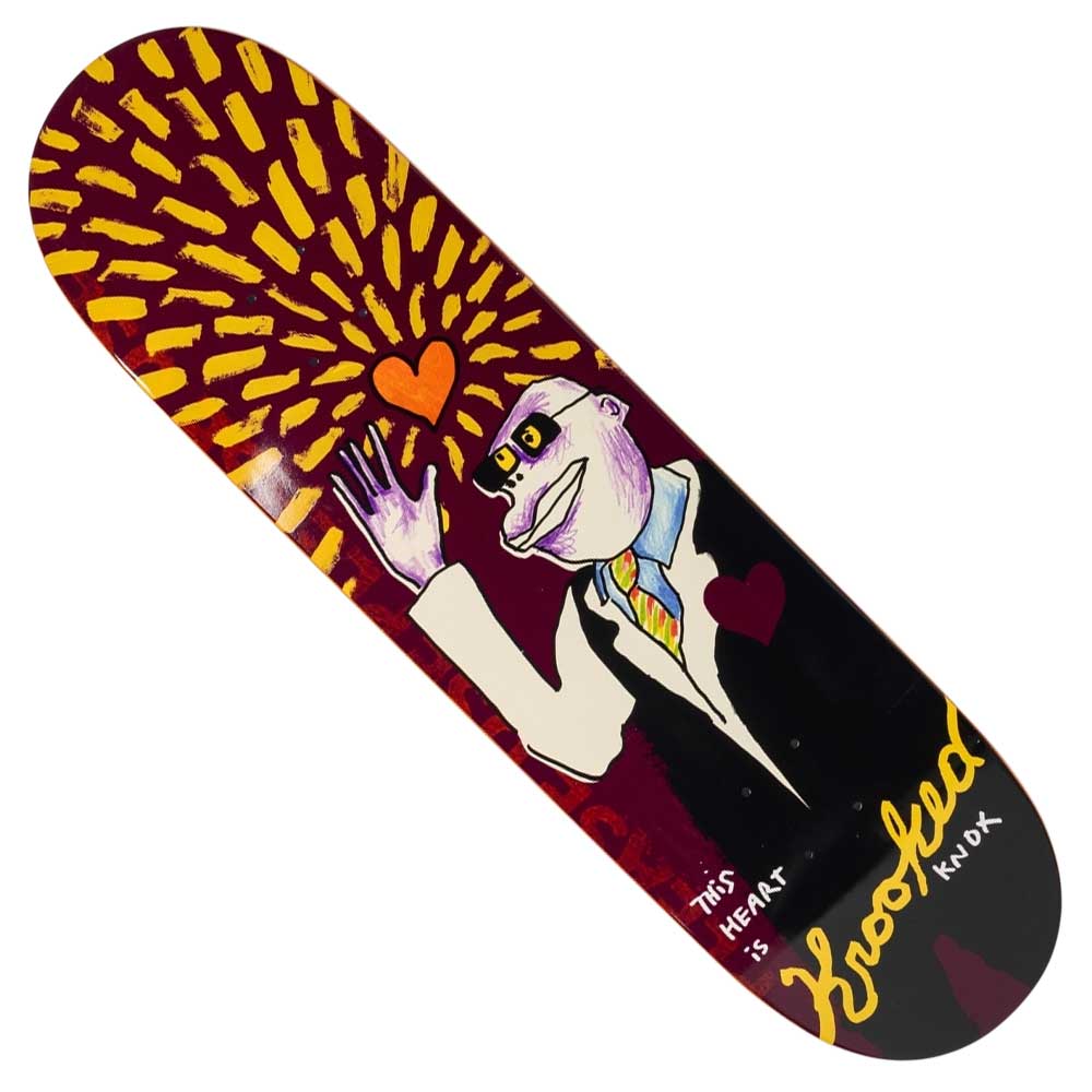 The This Heart Knox 8.5 Krooked Skateboard Deck features a cartoon figure in a suit with a heart on its chest, waving under yellow rays and an orange heart. "THIS HEART IS HOODED KNOX" appears across this unique design.